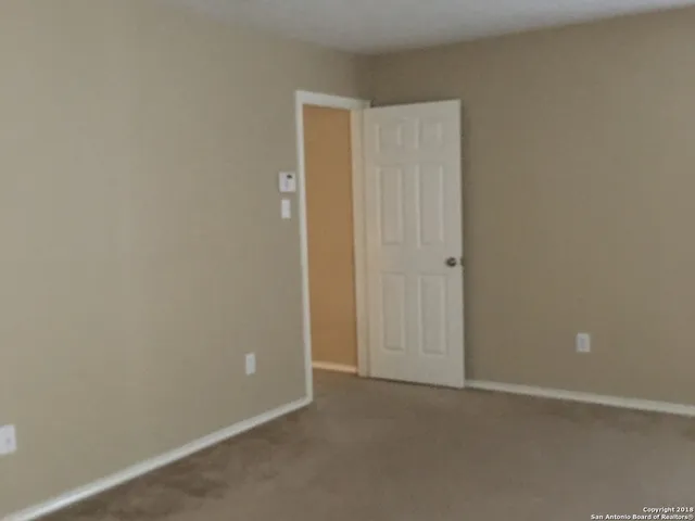 an empty room with closet area