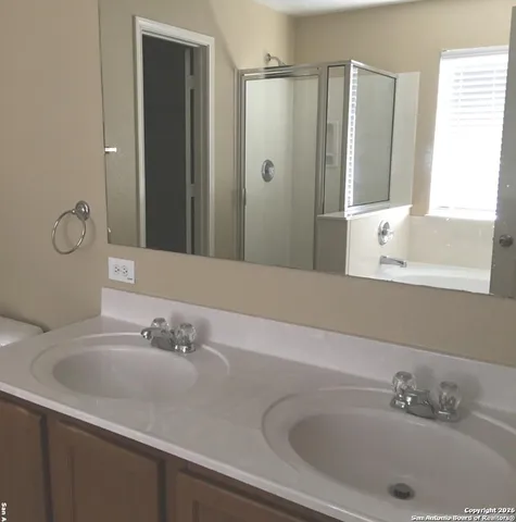 a bathroom with a tub sink and mirror