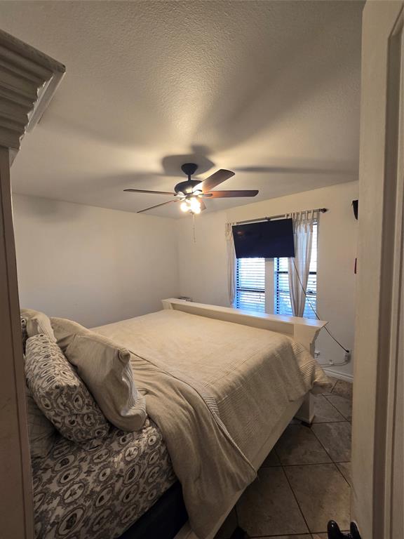 222 West Shady Grove Road, Unit 222 Irving, TX 75060 - Photo 18 of 37 a bedroom with a bed and a window