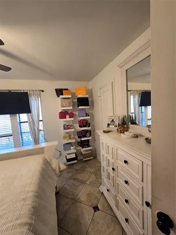 a large bedroom with a bed and a chandelier