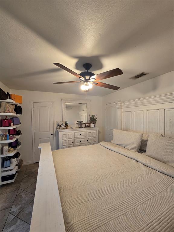222 West Shady Grove Road, Unit 222 Irving, TX 75060 - Photo 20 of 37 a large bedroom with a bed and a chandelier