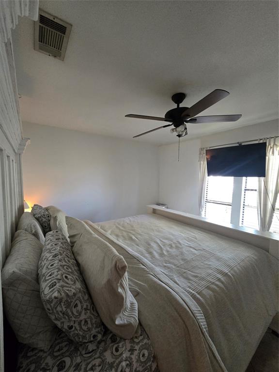 222 West Shady Grove Road, Unit 222 Irving, TX 75060 - Photo 21 of 37 a bedroom with a bed and a window