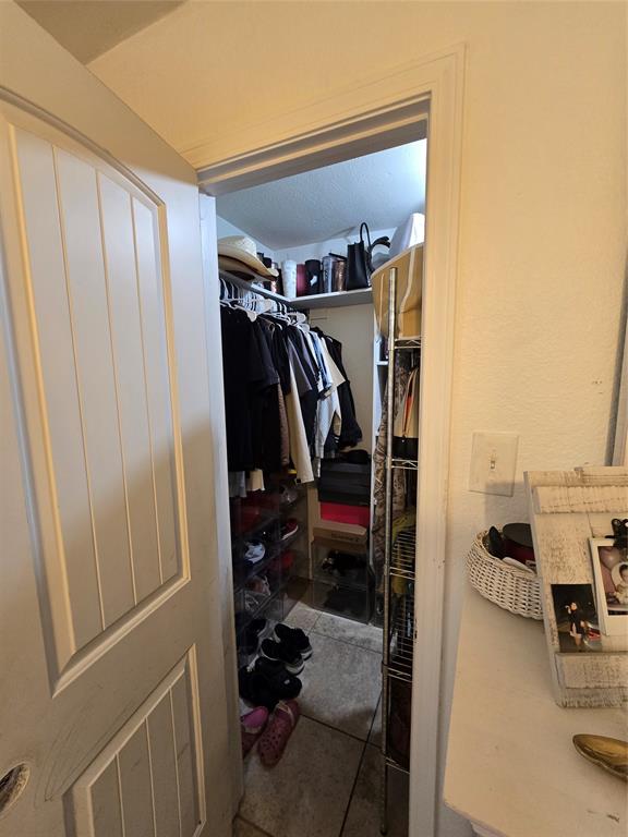 222 West Shady Grove Road, Unit 222 Irving, TX 75060 - Photo 25 of 37 a view of walk in closet with clothes and shoes