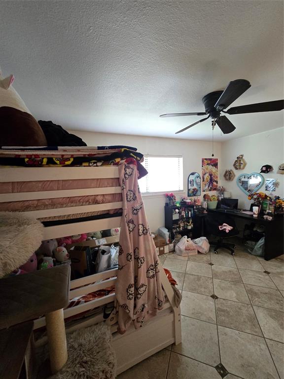 222 West Shady Grove Road, Unit 222 Irving, TX 75060 - Photo 26 of 37 a living room with lots of furniture and a fan