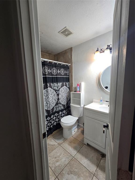 222 West Shady Grove Road, Unit 222 Irving, TX 75060 - Photo 29 of 37 a bathroom with a sink toilet and shower