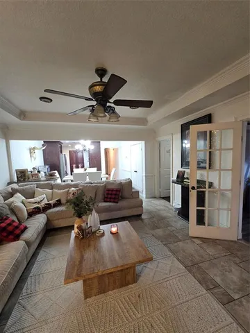 a living room with furniture and kitchen view