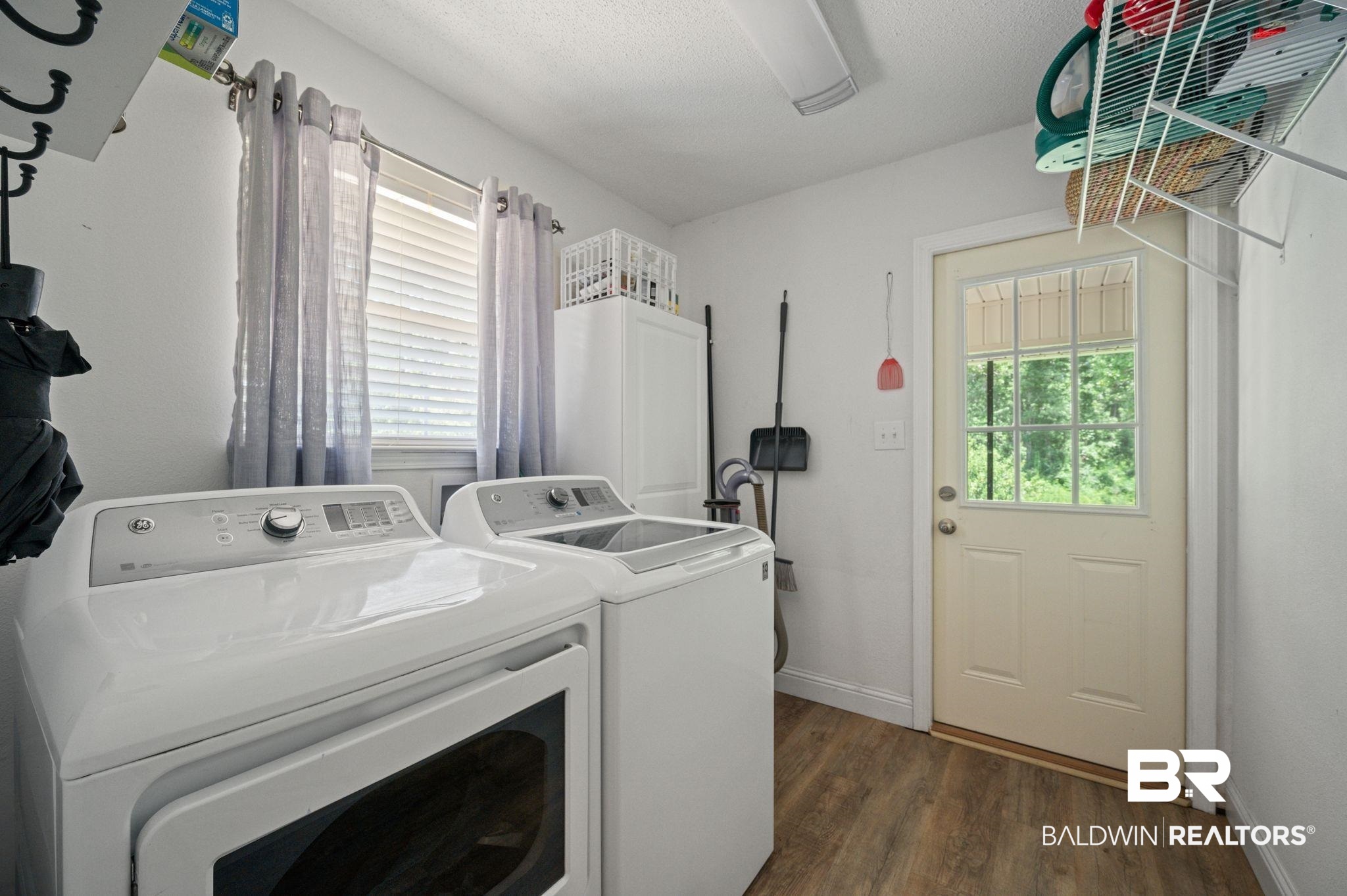 11705 Venice Boulevard Foley, AL 36535 - Photo 7 of 43 Washroom with dark hardwood / wood-style floors and washer and clothes dryer