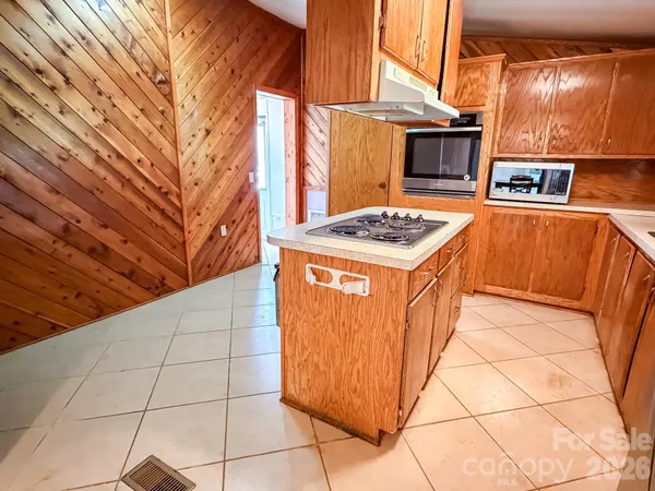 a stove top oven sitting inside of a kitchen