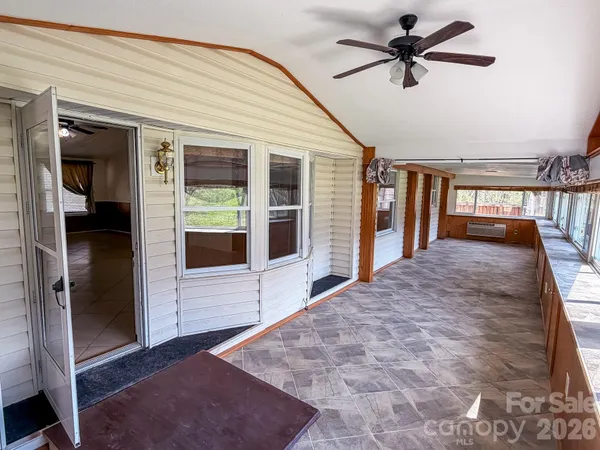 a view of a hallway with a ceiling fan