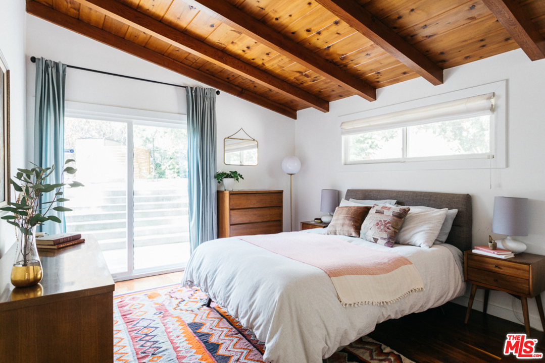 3506 Canyon Crest Road Altadena, CA 91001 - Photo 16 of 25 a bedroom with a bed and a dresser next to a window