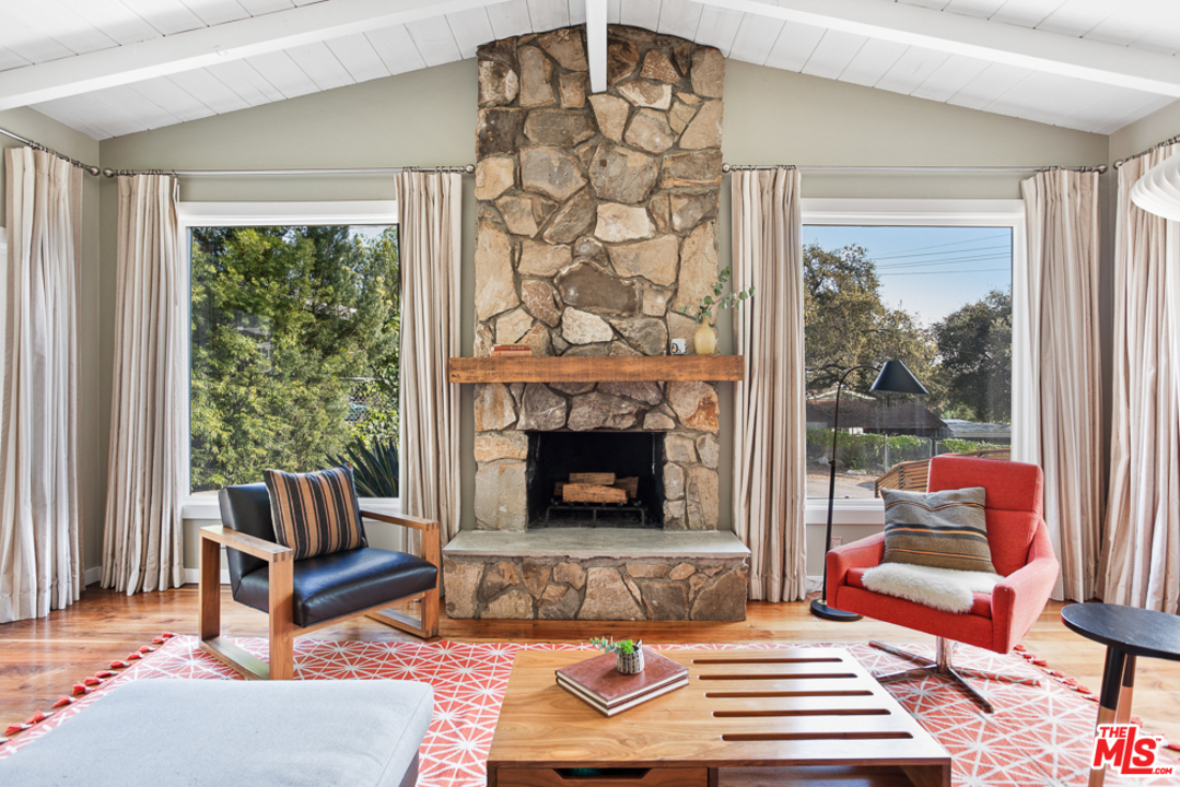 3506 Canyon Crest Road Altadena, CA 91001 - Photo 4 of 25 a living room with a couch and a fireplace