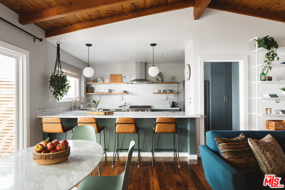 3506 Canyon Crest Road Altadena, CA 91001 - Photo 6 of 25 a room with stainless steel appliances kitchen island granite countertop furniture and a wooden floor