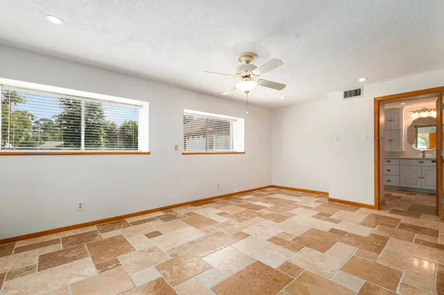 a spacious bathroom with a toilet sink and mirror