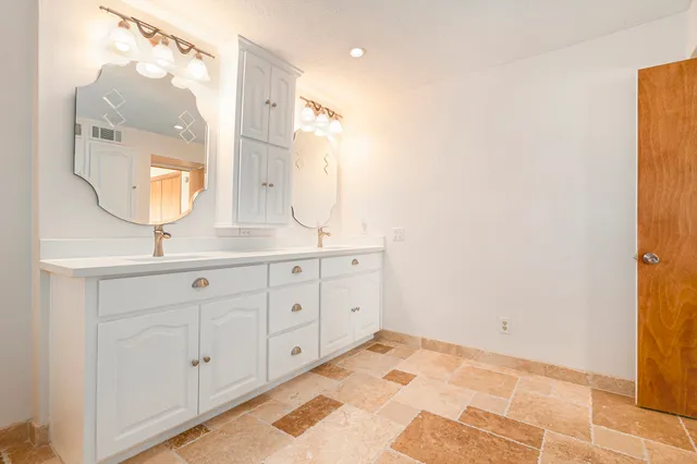 a view of a big room with windows and chandelier