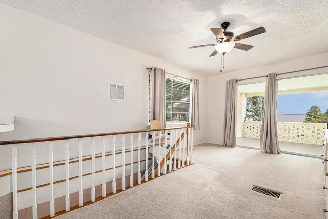 a view of a workspace with furniture and a window