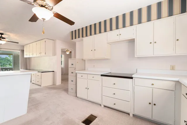 a living room with furniture and large windows