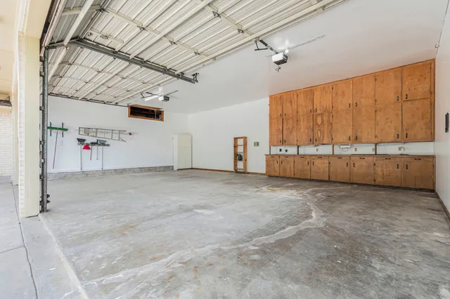 an aerial view of a house with a yard and lake view