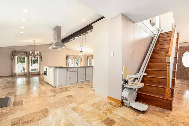 a kitchen with granite countertop white cabinets and white appliances