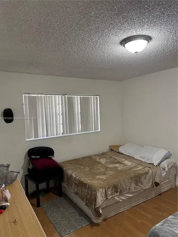 a bedroom with a bed and a chair