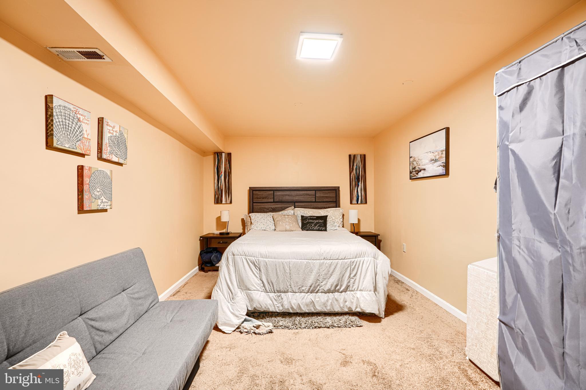 4 High Side Court Owings Mills, MD 21117 - Photo 26 of 30 a bedroom with a bed and a couch