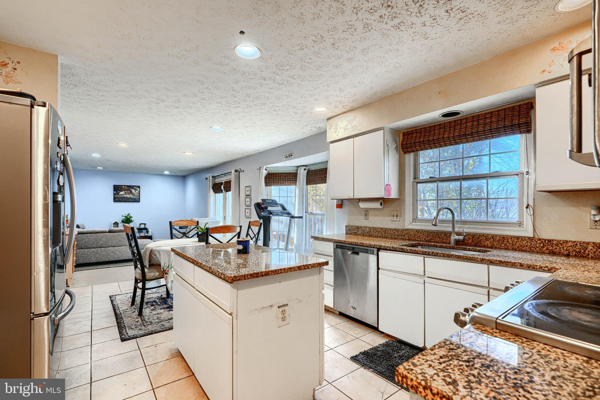 4 High Side Court Owings Mills, MD 21117 - Photo 6 of 30 a kitchen with stainless steel appliances granite countertop a sink dishwasher a stove and a refrigerator with wooden floor