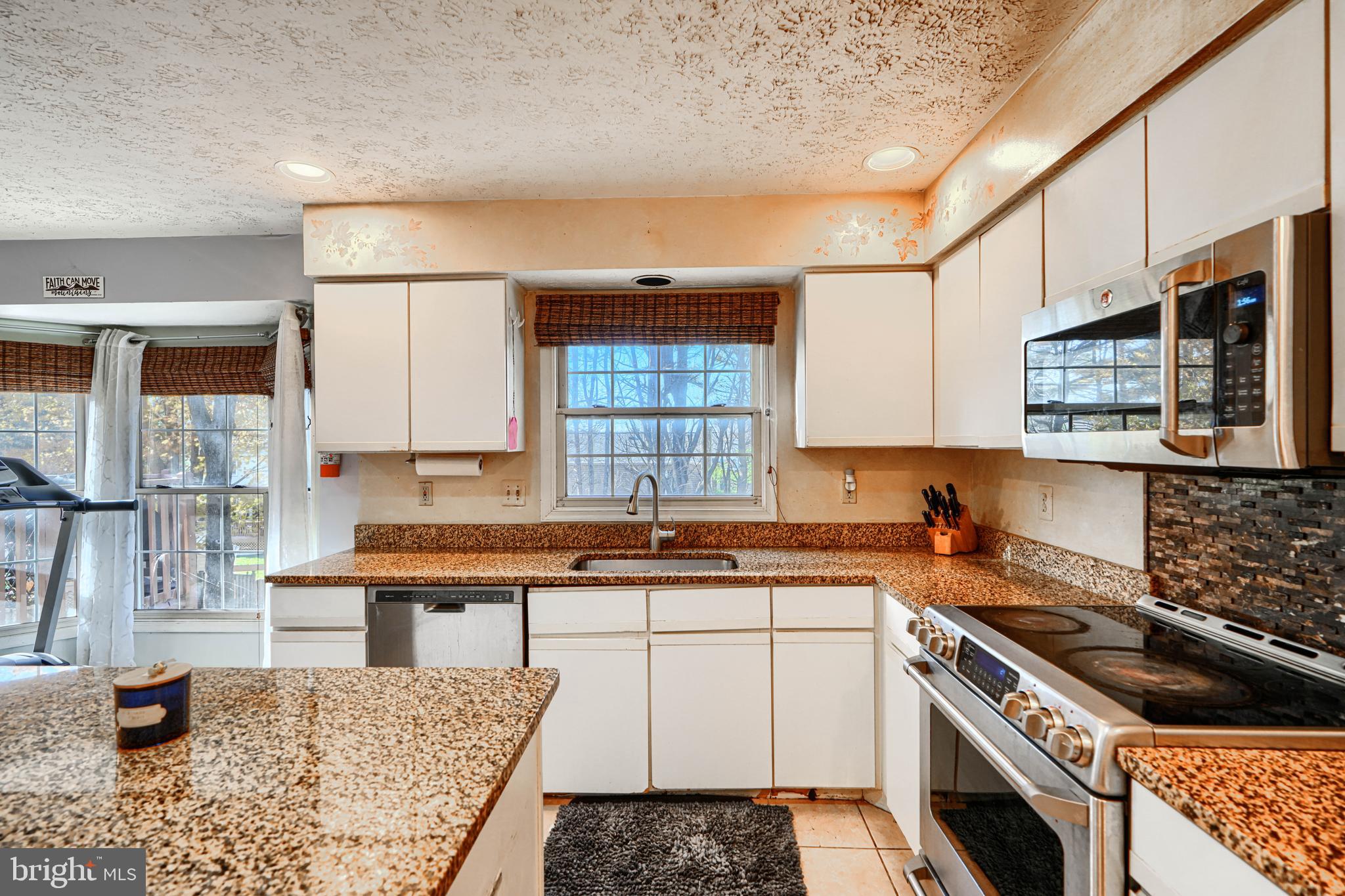 4 High Side Court Owings Mills, MD 21117 - Photo 7 of 30 a kitchen with a sink stove and cabinets