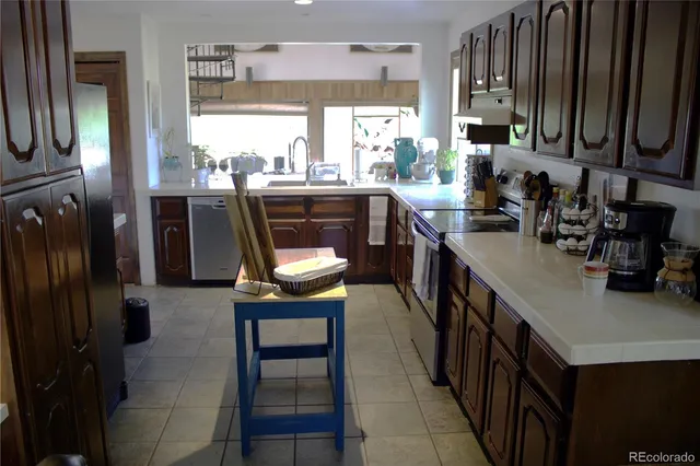 a kitchen with stainless steel appliances a sink stove and a refrigerator