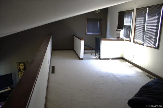 a view of an empty room with a fireplace