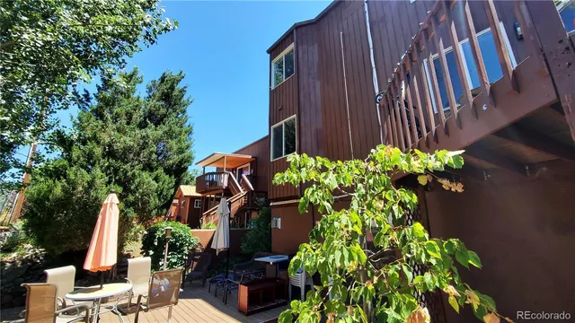 a view of balcony with wooden floor and outdoor seating