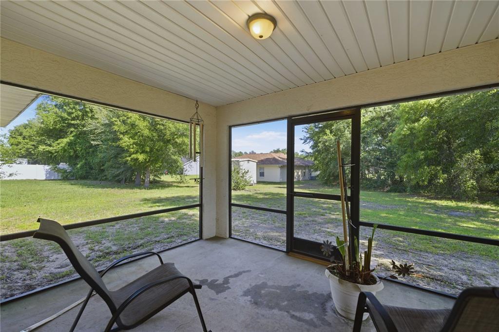 3959 Southwest 129th Street Ocala, FL 34473 - Photo 19 of 27 a view of a two chairs in the patio next to a yard