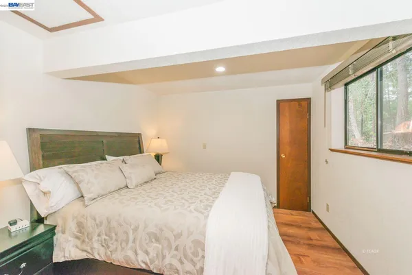 a bed room with a bed and a large window