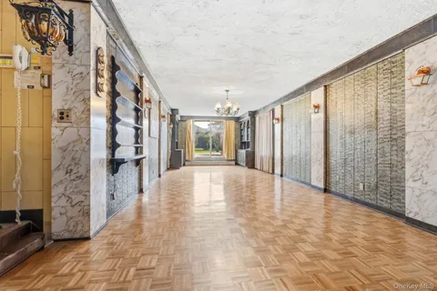a view of an entryway with wooden floor and door