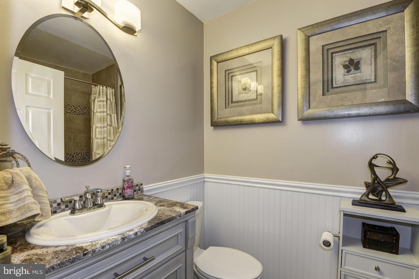 6203 Apache Street Springfield, VA 22150 - Photo 14 of 22 a bathroom with a toilet sink and mirror