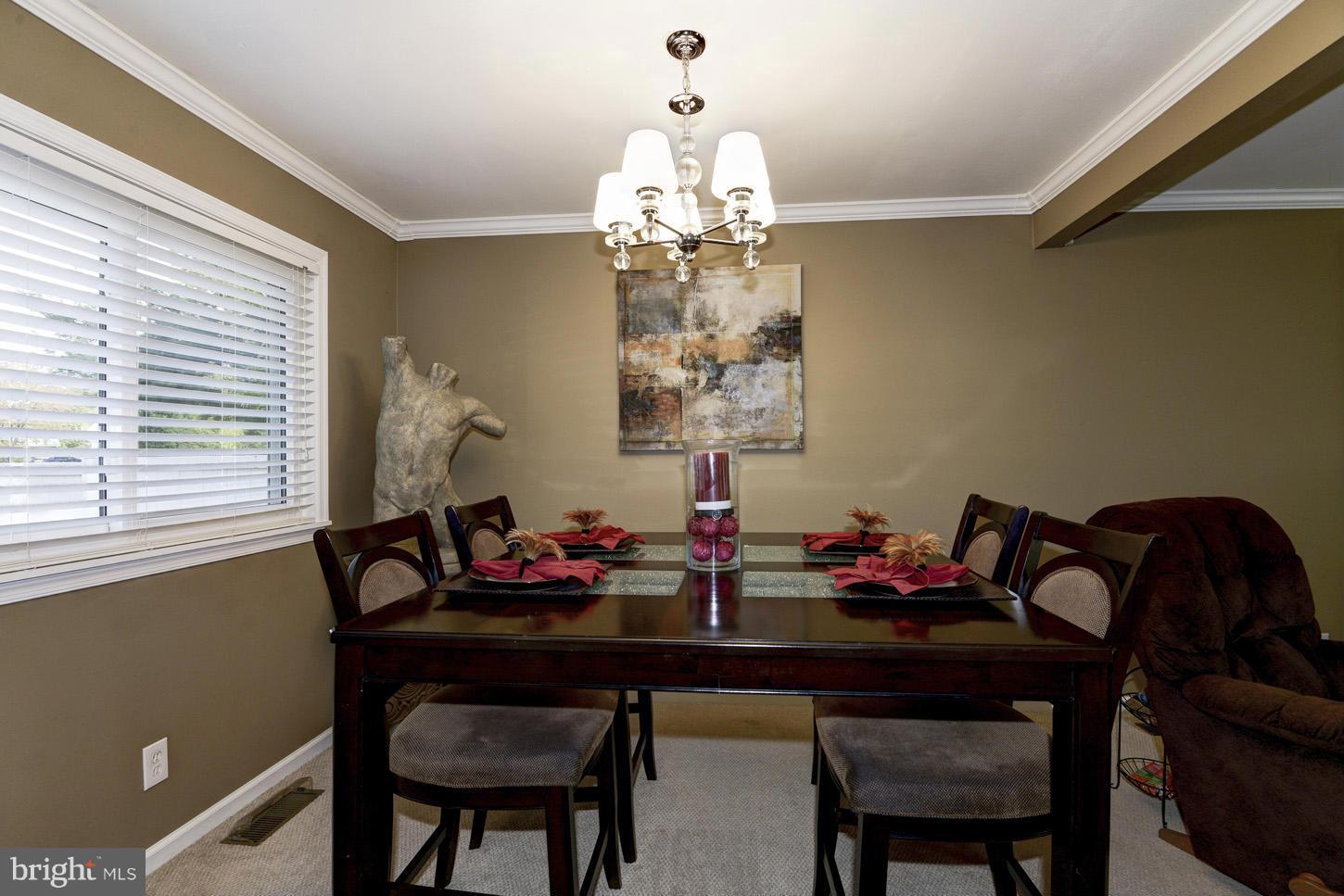 6203 Apache Street Springfield, VA 22150 - Photo 7 of 22 a table and chairs in a room