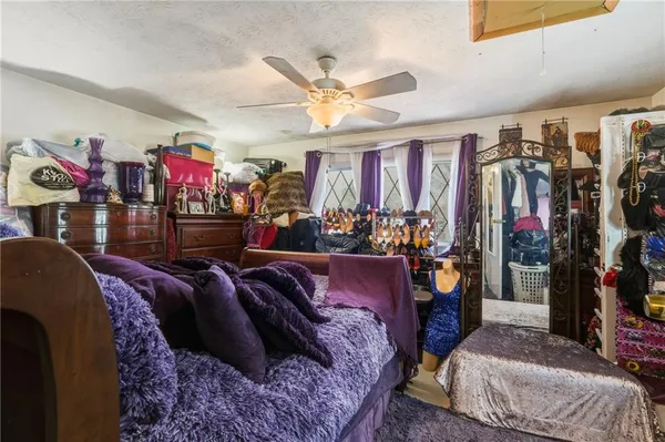 a bed room with a bed mirror and a ceiling fan