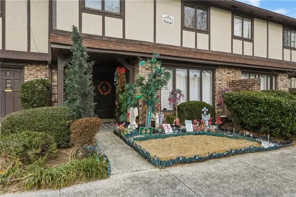 a view of a house with potted plants