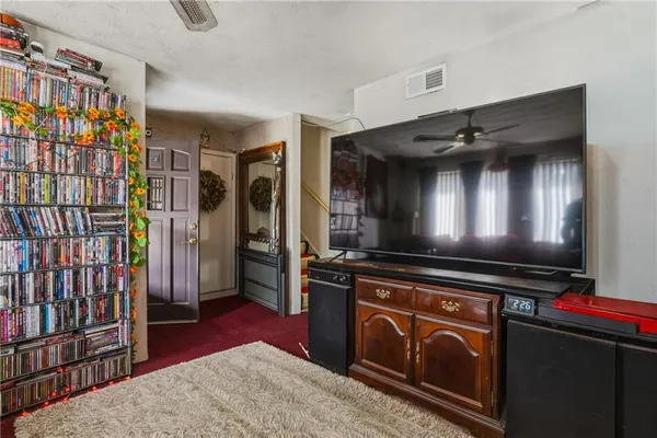 a kitchen with stainless steel appliances kitchen island granite countertop a stove refrigerator and cabinets
