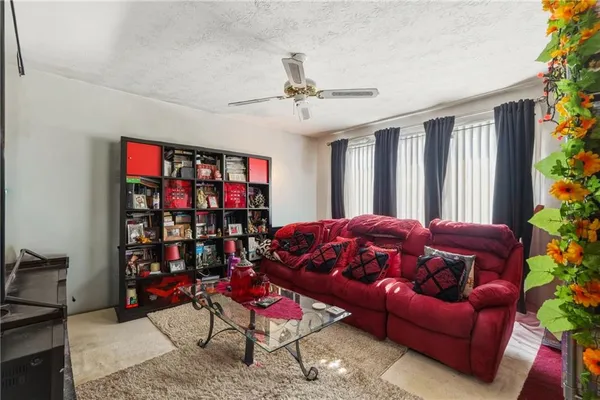 a living room with patio furniture and a window