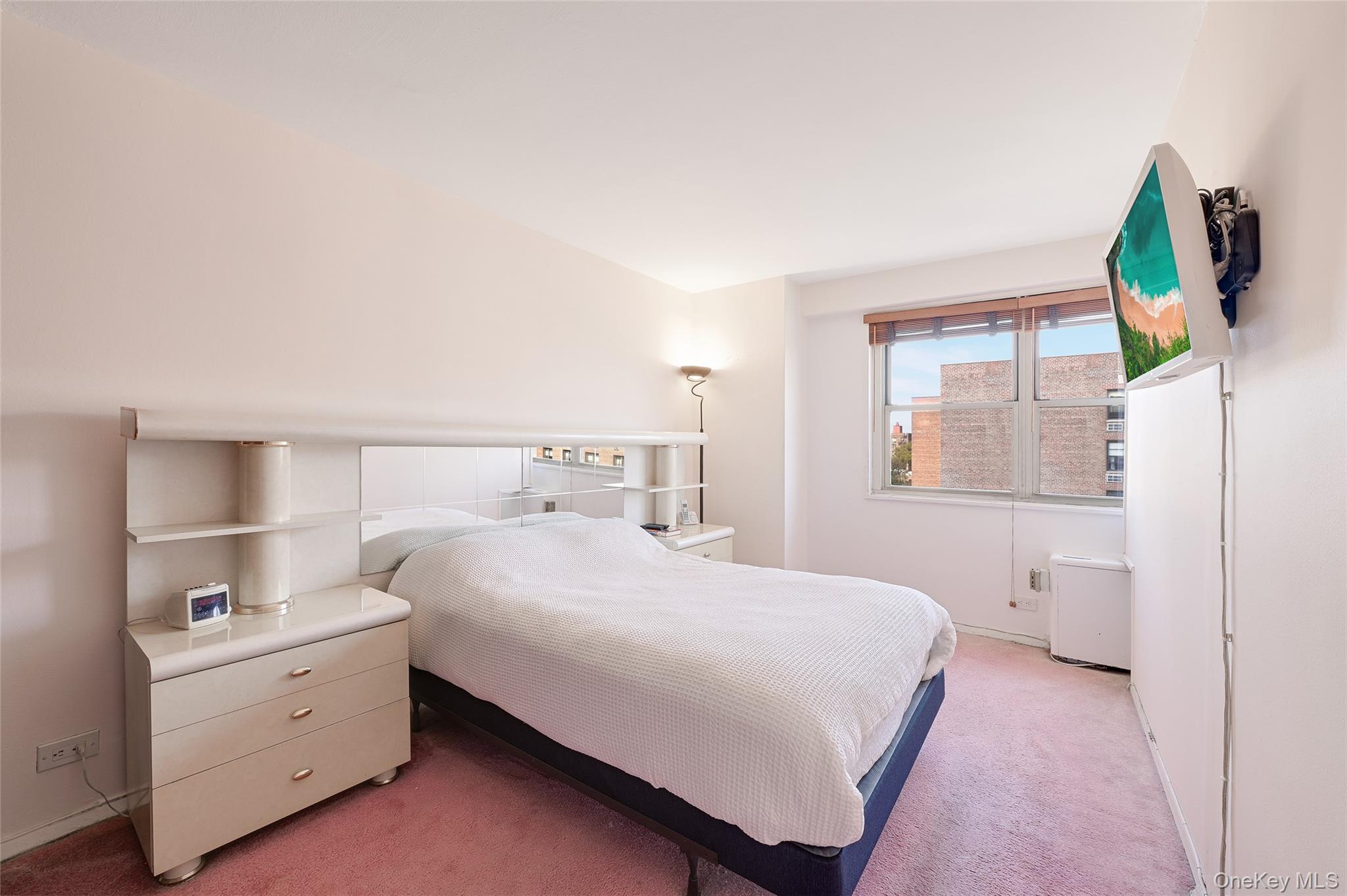 102-30 66th Road, Unit 6C Queens, NY 11375 - Photo 3 of 5 a bedroom with a bed and a window