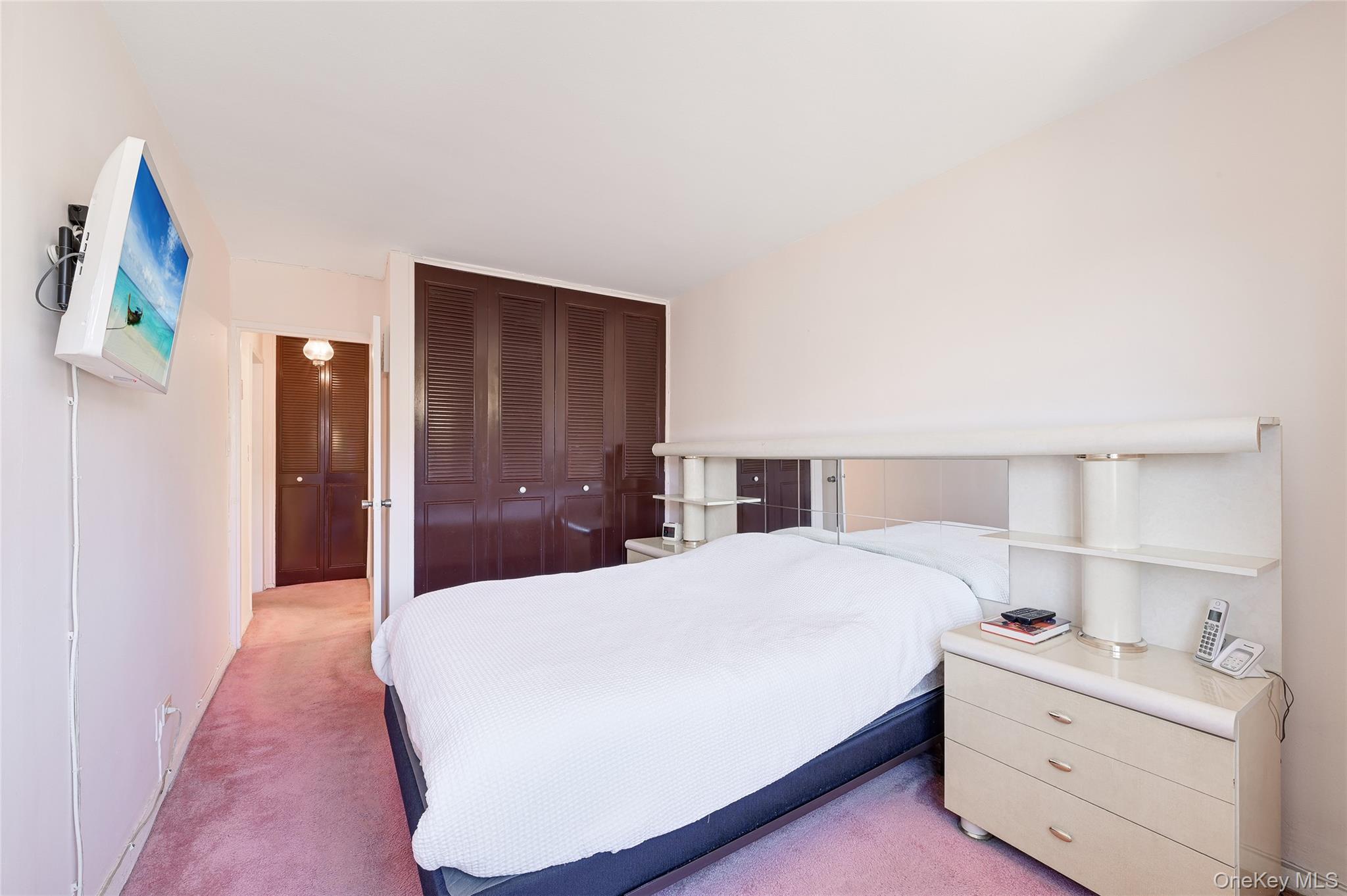 102-30 66th Road, Unit 6C Queens, NY 11375 - Photo 4 of 5 a bedroom with a bed and a closet