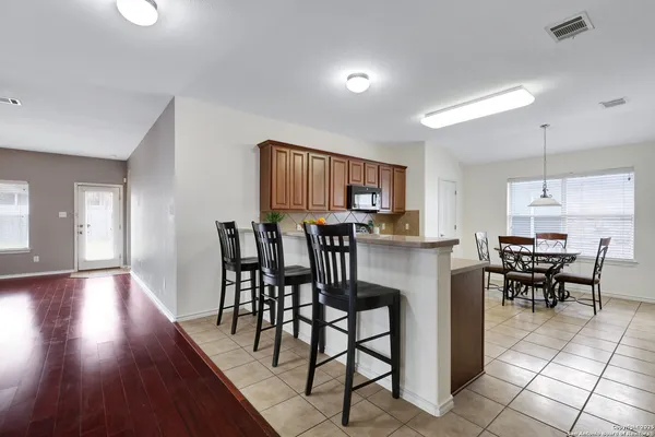 a view of a dining room with furniture and wooden floor