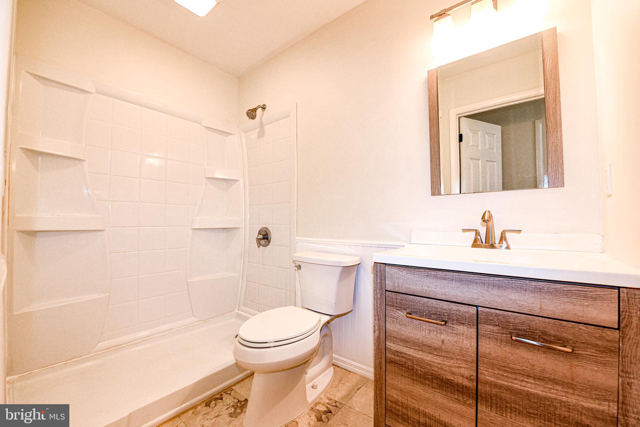 18 B Acorn Road Manahawkin, NJ 08050 - Photo 14 of 19 a bathroom with a sink a toilet and shower