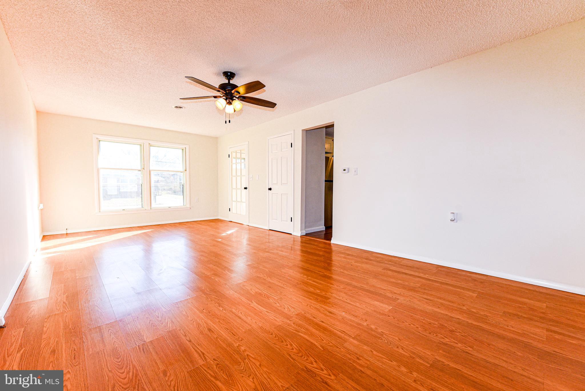 18 B Acorn Road Manahawkin, NJ 08050 - Photo 6 of 19 a view of empty room with wooden floor and fan