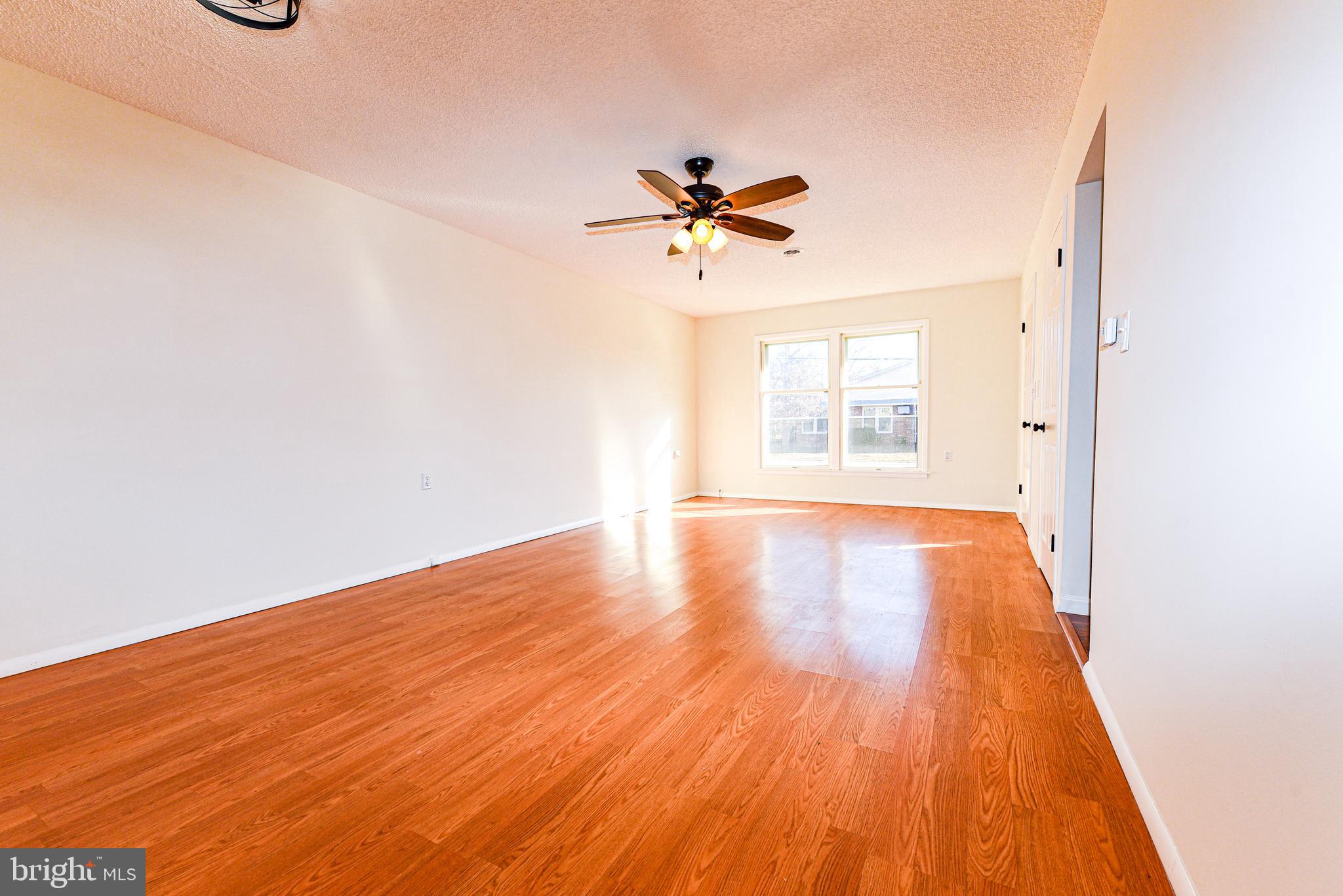 18 B Acorn Road Manahawkin, NJ 08050 - Photo 7 of 19 wooden floor in an empty room with a window