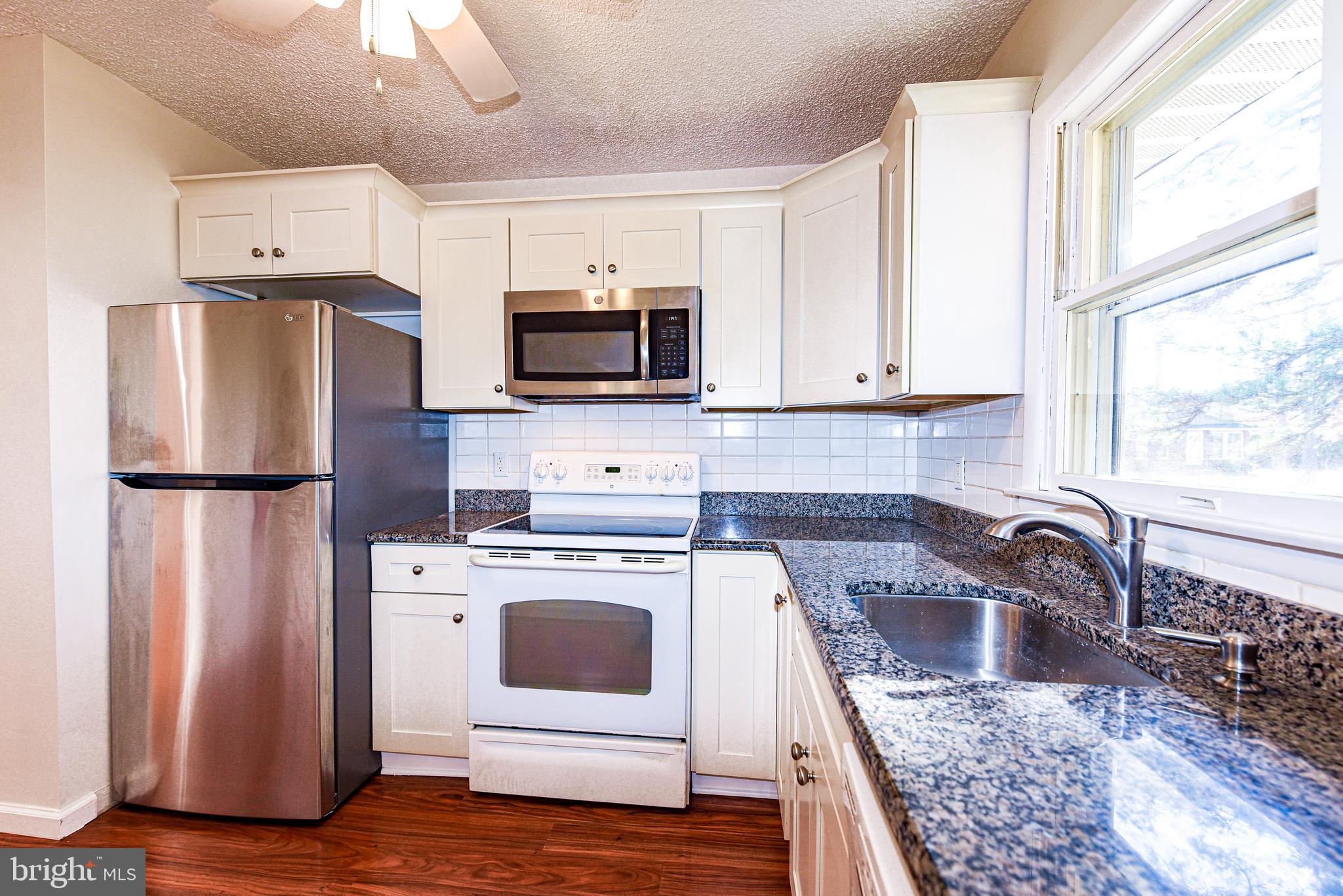 18 B Acorn Road Manahawkin, NJ 08050 - Photo 9 of 19 a kitchen with appliances a sink and a counter top space