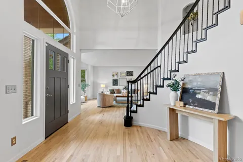 a view of entryway and hall with wooden floor