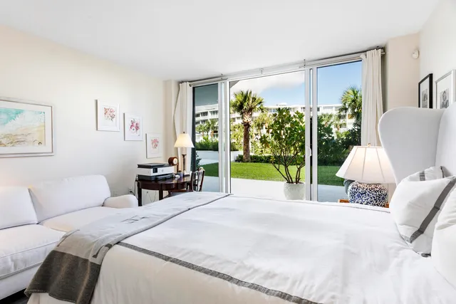 a kitchen with granite countertop stainless steel appliances a refrigerator a stove a sink and a window