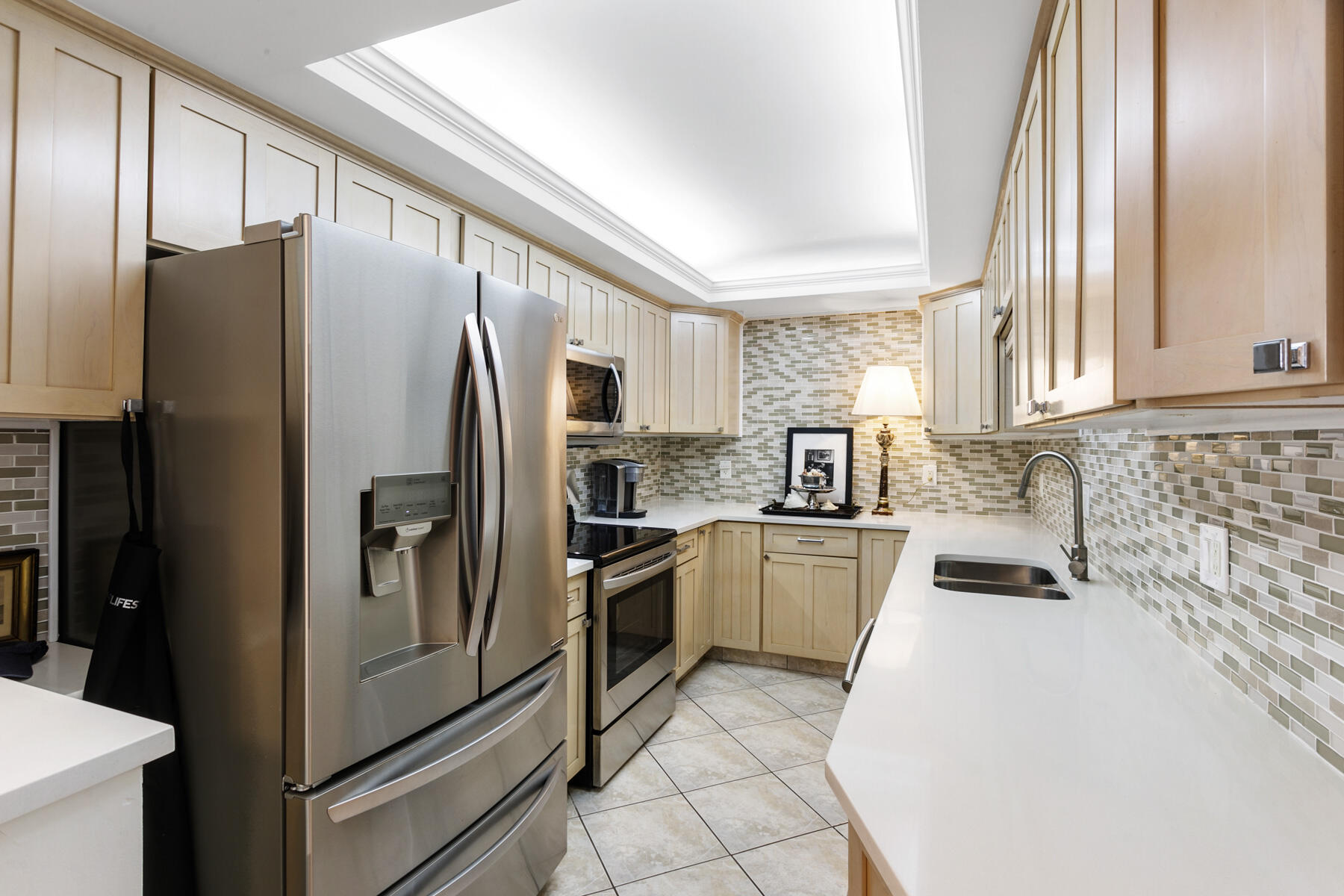 2773 South Ocean Boulevard, Unit 109 Palm Beach, FL 33480 - Photo 15 of 36 a kitchen with granite countertop stainless steel appliances a refrigerator a stove a sink and a window