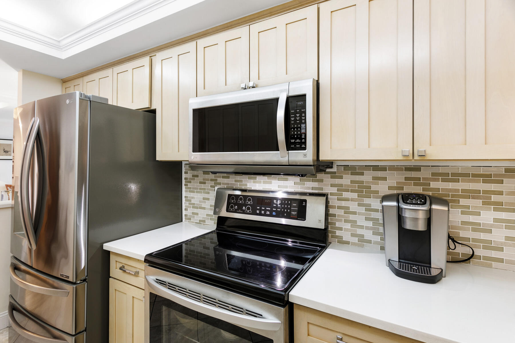 2773 South Ocean Boulevard, Unit 109 Palm Beach, FL 33480 - Photo 16 of 36 a kitchen with stainless steel appliances granite countertop a refrigerator stove and microwave