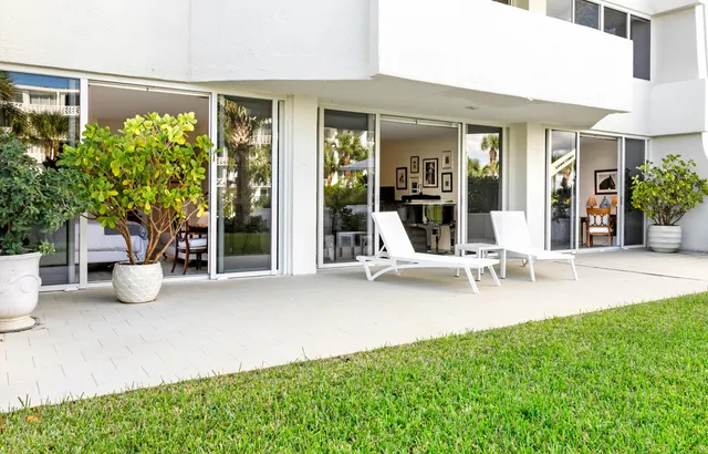 a view of a patio with a table and chairs